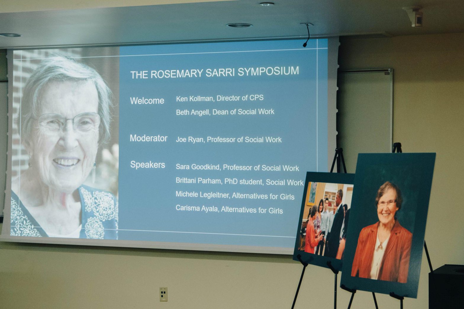 Photo of the Rosemary Sarri Symposium showing Sarri's portraits on display at ISR