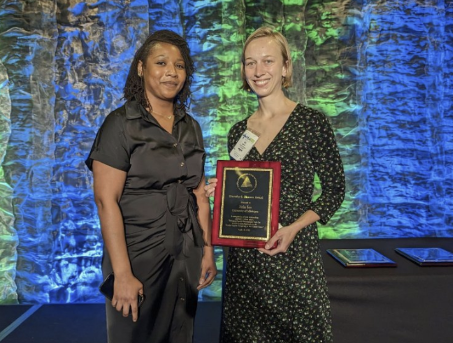 PSC alum Christina Cross bestows the Dorothy A. Thomas Award on PSC trainee Erin Ice at PAA 2023.