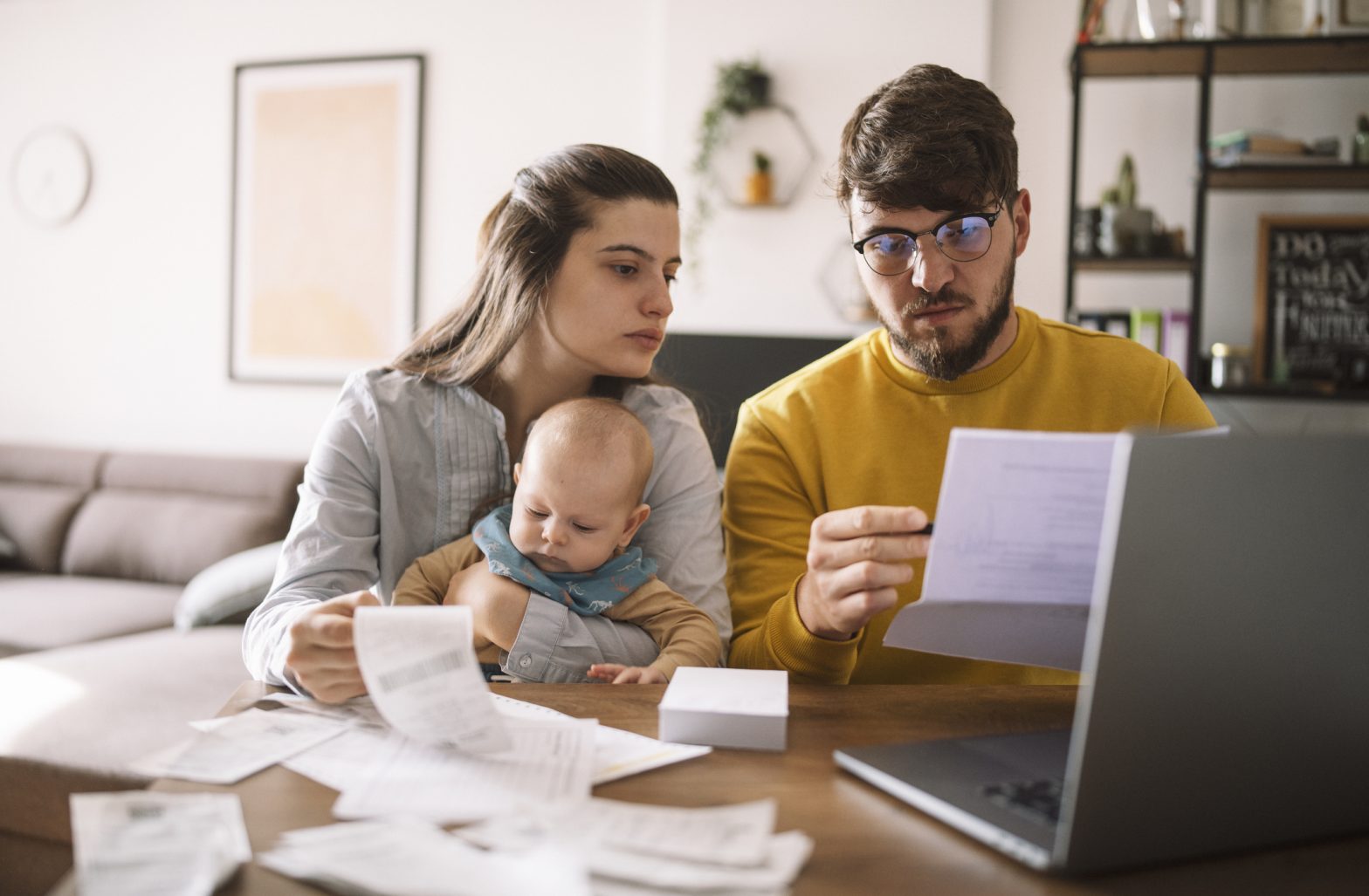 Young family with baby worried about family budget and bills.