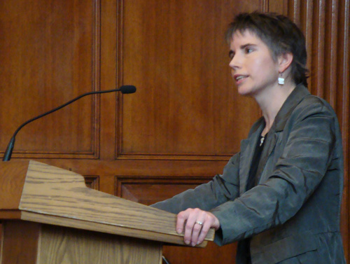 Nancy Burns speaks at a lectern