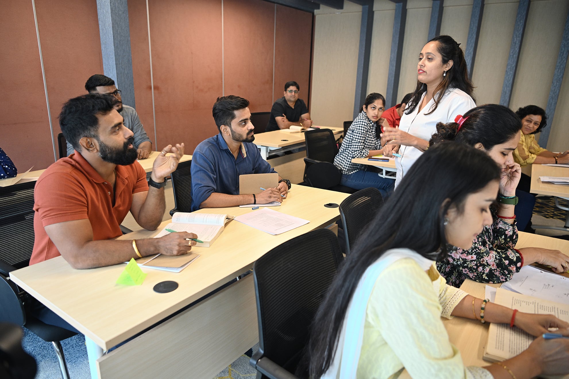 Female professor explaining to mature adult students in the classroom